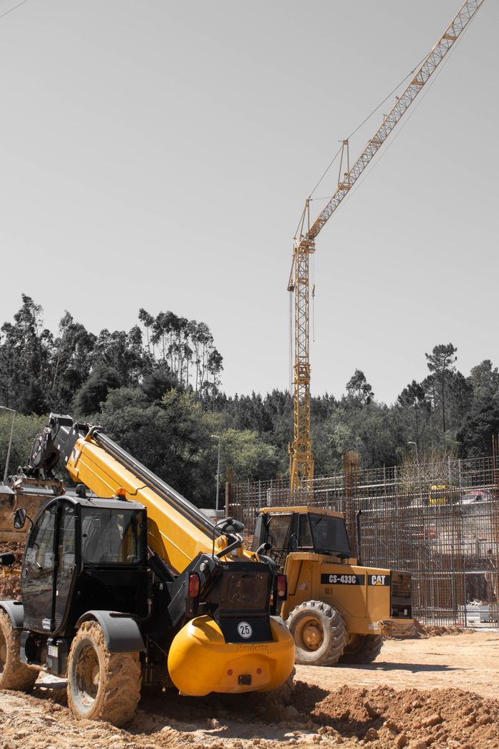 A vibrant construction site featuring cranes and heavy machinery in action.